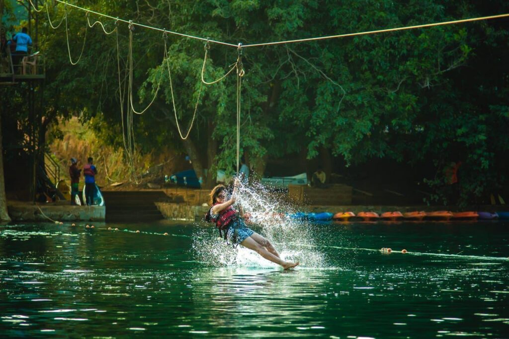 People enjoying a zipline adventure through the forest canopy in Dandeli